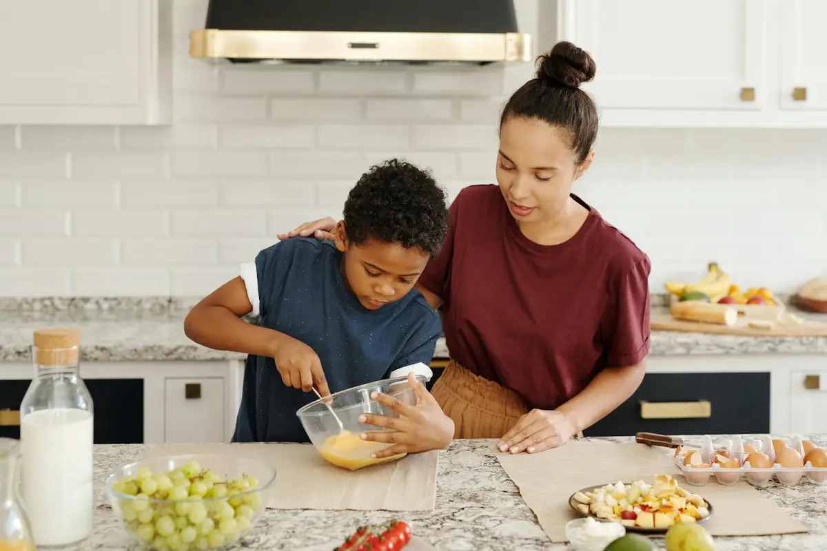 A parent and child preparing a meal together at home